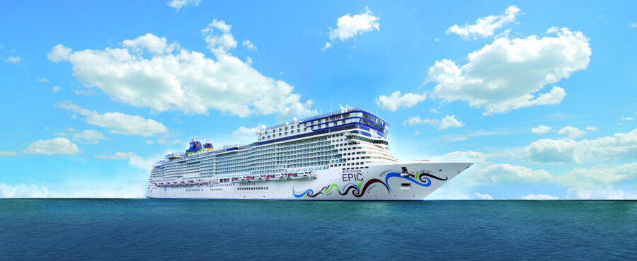 The Norwegian Epic cruise ship, a large vessel with a distinctive hull design, sailing on calm blue waters under a partly cloudy sky.