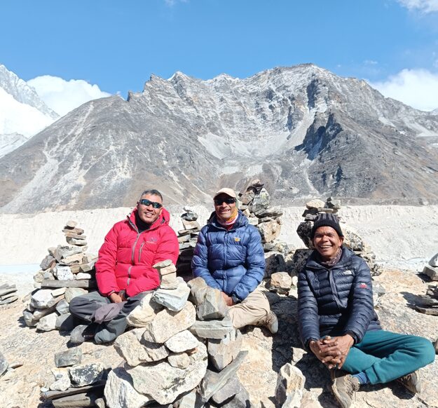 Travel Escapes Guides taking a well deserved break as they sit in the sunshine with backdrop of Mountain