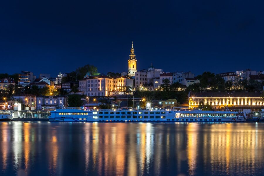 Night-time view of the Belgrade, Serbia skyline from the river, showing the illuminated St. Michael's Cathedral on the Crossroads of Culture tour.