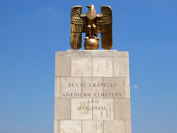 The memorial tower with a golden eagle at the Henri-Chapelle American Cemetery in Belgium.