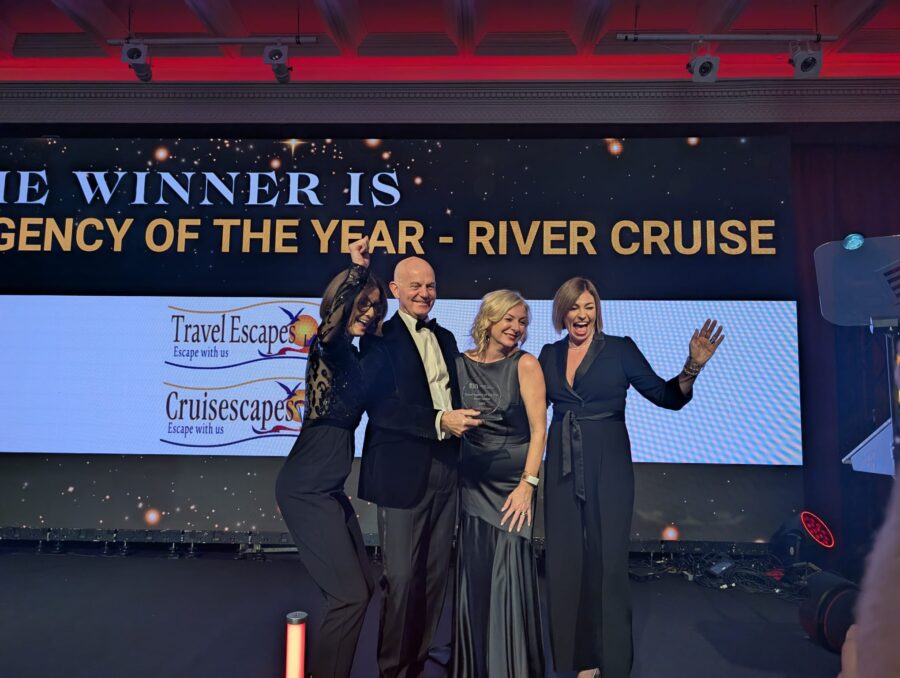 Travel Escapes team members Alan and Celine celebrating on stage at the ITTN Awards after winning Travel Agency of the Year 2025 for River Cruising.