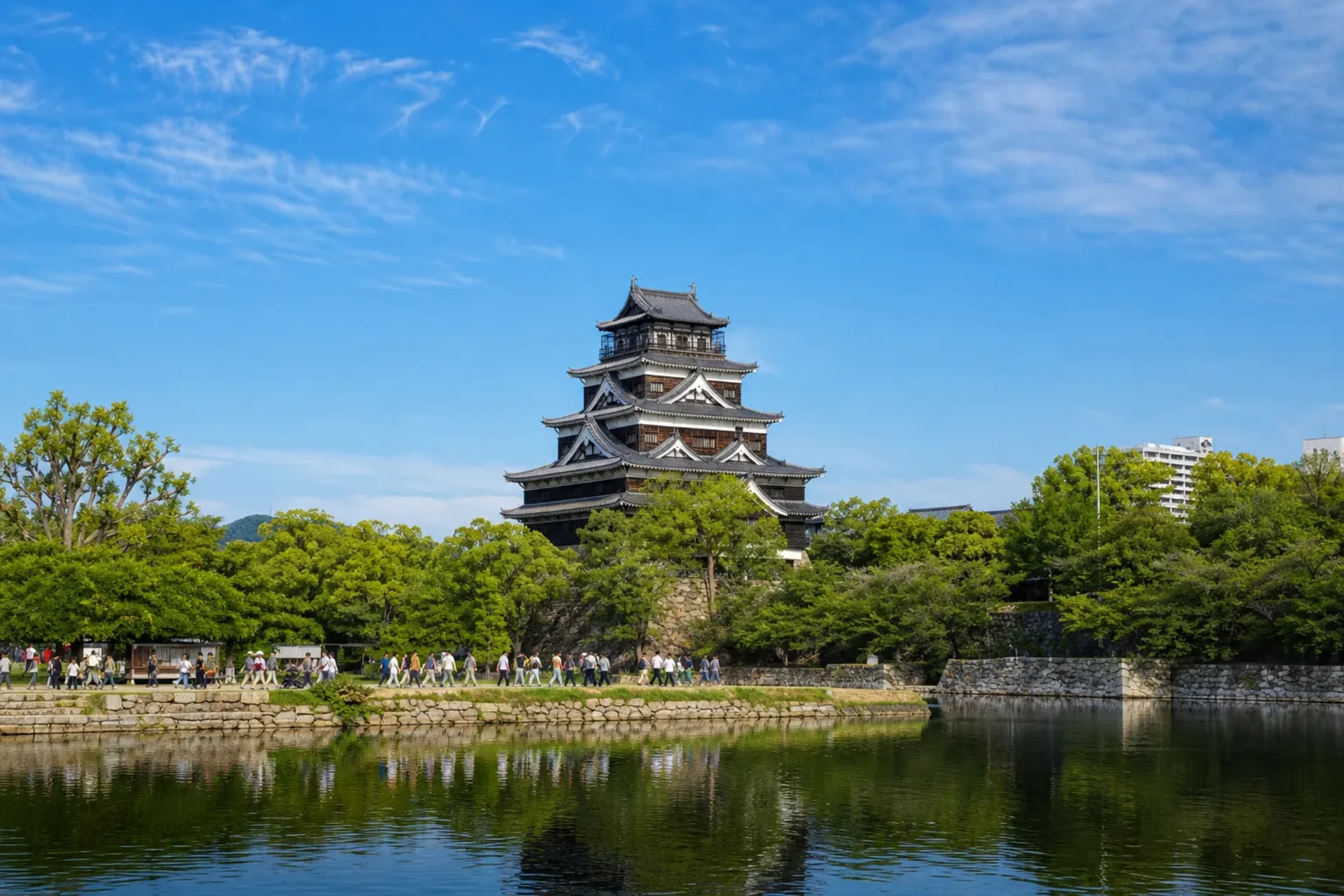 Japan-Hiroshima Castle reflected in its moat during a Japan 2027 tour.