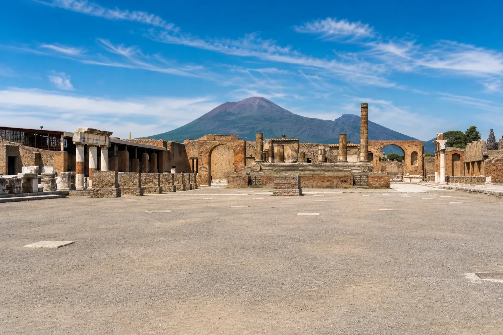 Italy-The ancient ruins of Pompeii with Mount Vesuvius in the background on a sunny Sorrento Coast tour.