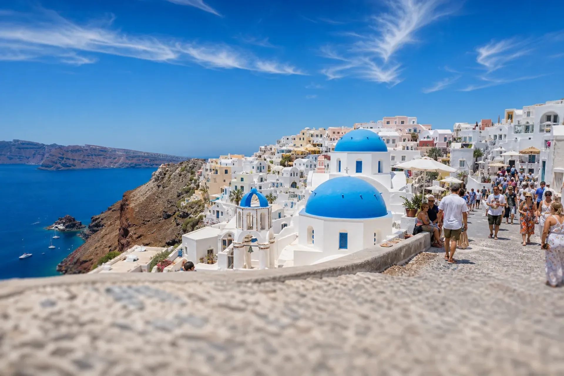 Greece & Turkey-A sun-filled view of the blue domes and white buildings of Santorini, a key stop on our Greek Isles Turkey cruise.