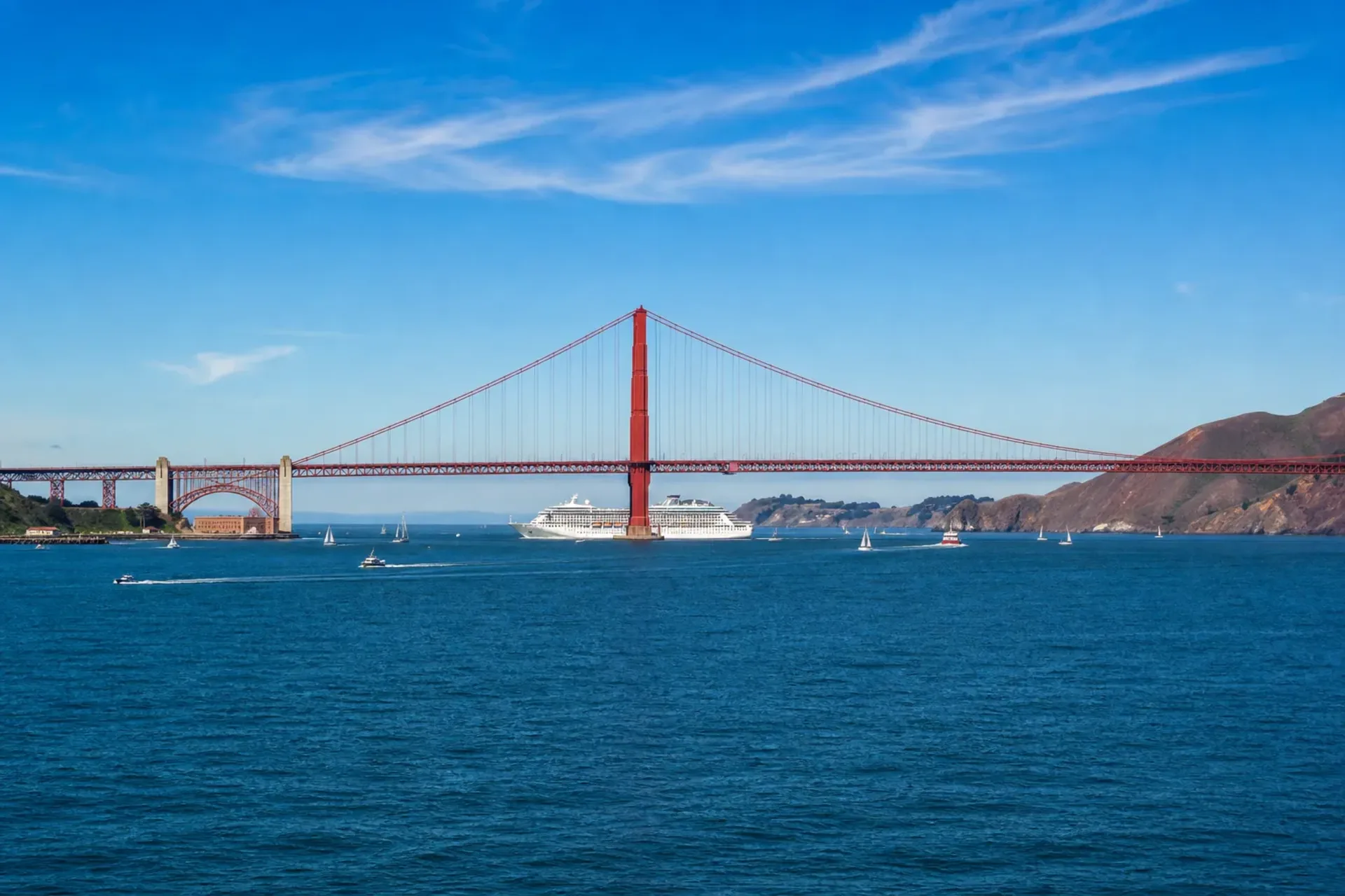 USA and Canada-A 5-star cruise ship sailing under the Golden Gate Bridge in San Francisco during a Pacific Coast cruise.