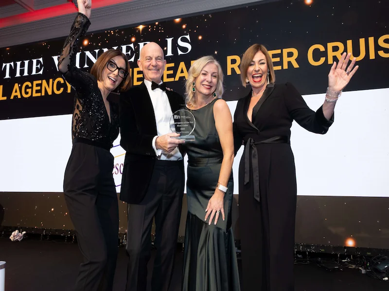 Travel Escapes team members Alan and Celine celebrating on stage at the ITTN Awards after winning Travel Agency of the Year 2025 for River Cruising.