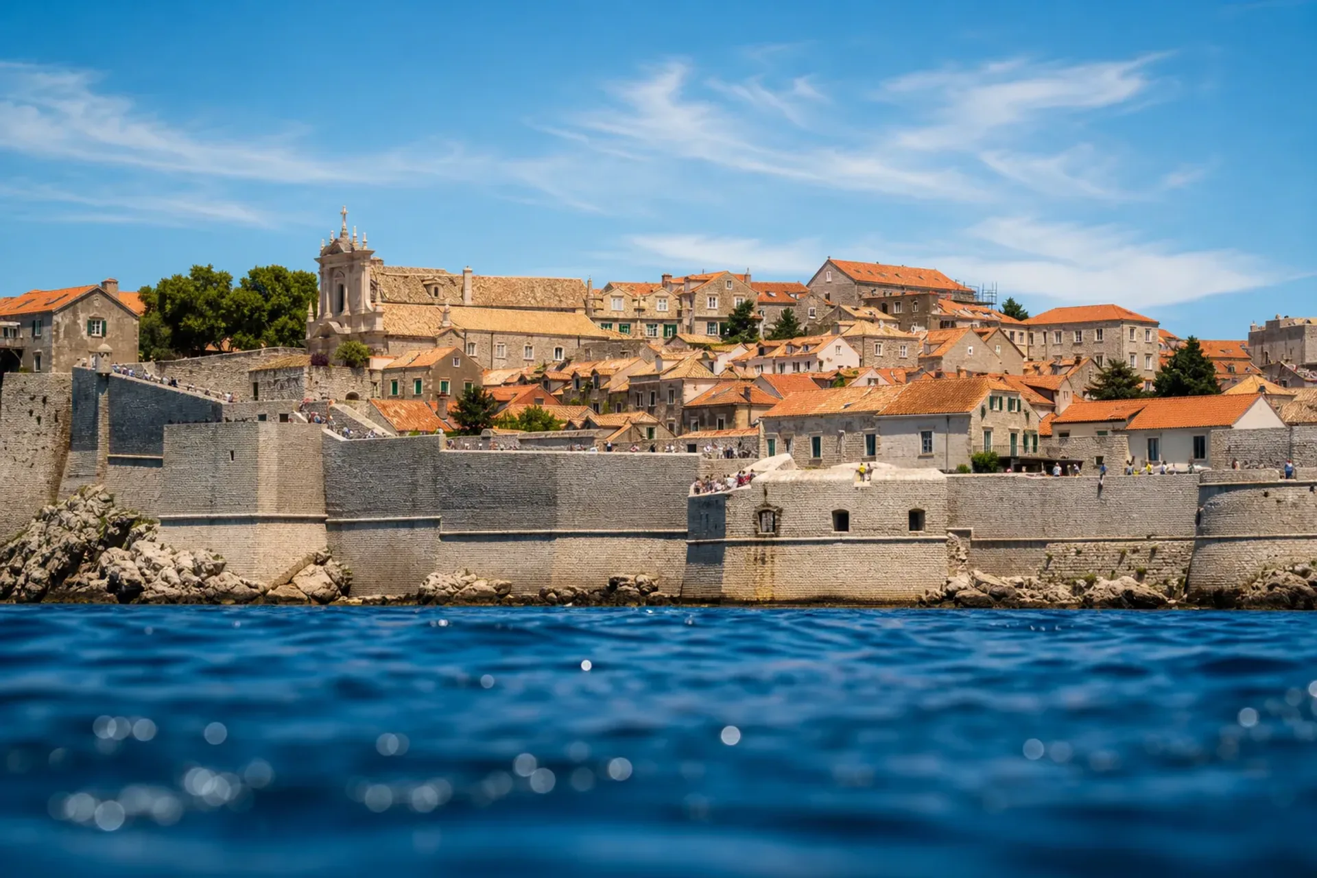 Greece, Croatia, Montenegro, Albania-The ancient city walls of Dubrovnik overlooking the blue sea during a Virgin Cruise Adriatic.