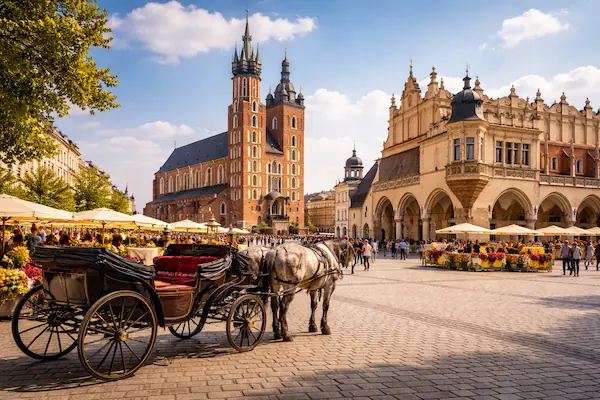A horse-drawn carriage in the historic Main Market Square of Krakow, Poland, a featured destination on our Eastern Europe escorted tours.