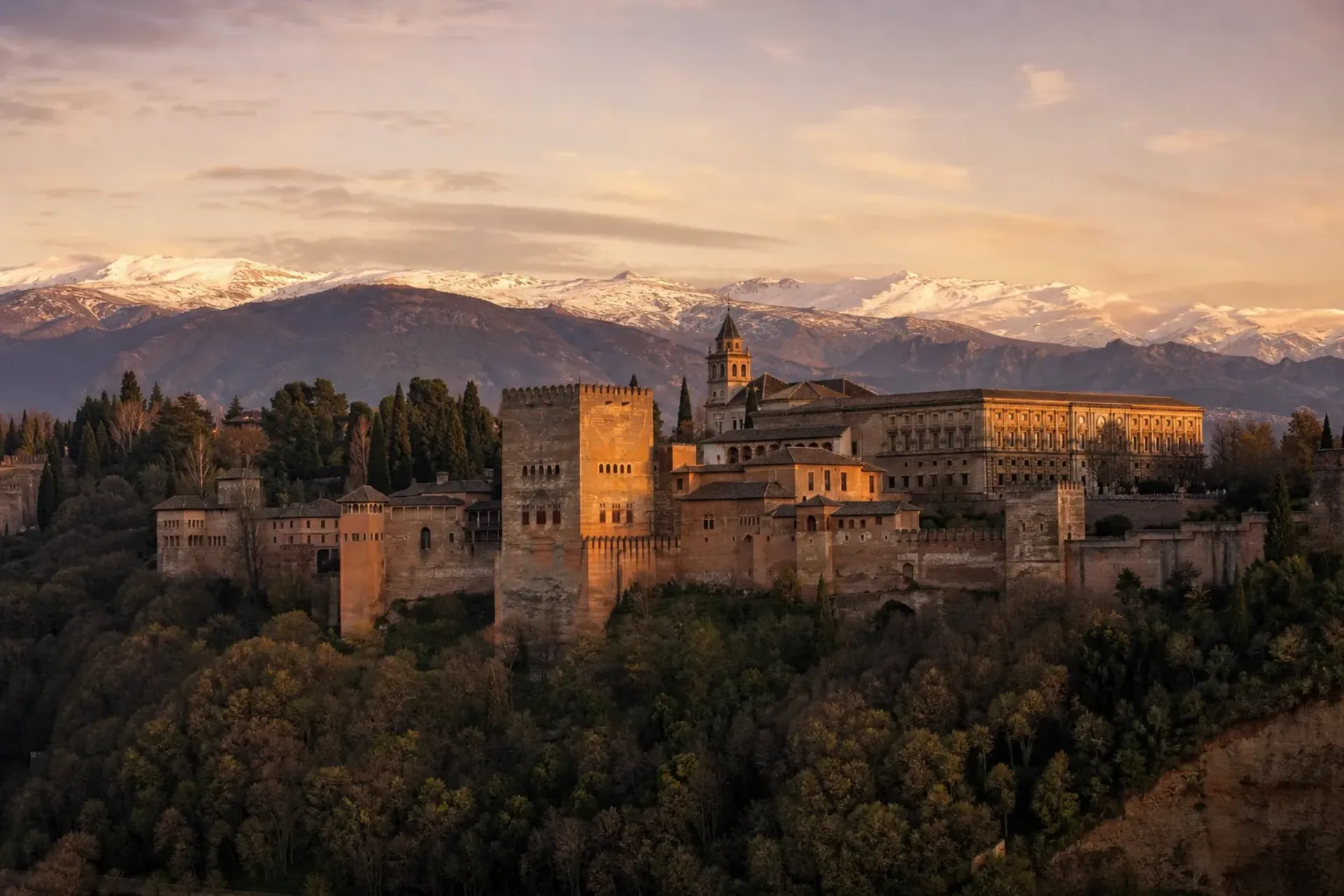 Spain-The majestic Alhambra Palace in Granada during a Classical Spain tour with the Sierra Nevada mountains in the background.
