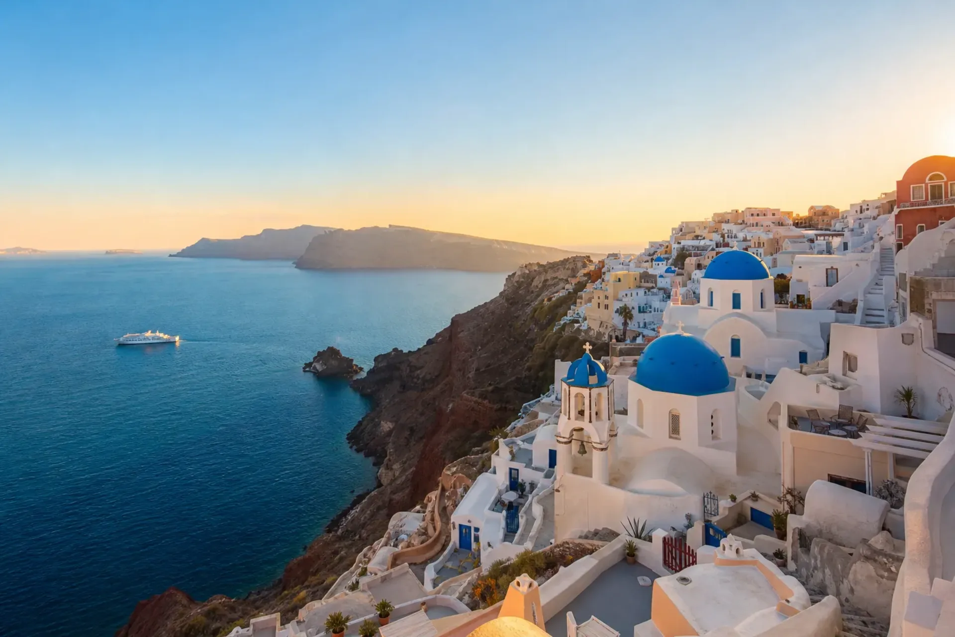 Greece and Turkey-A beautiful sunset view of Santorini's whitewashed buildings during a Greece Turkey cruise.