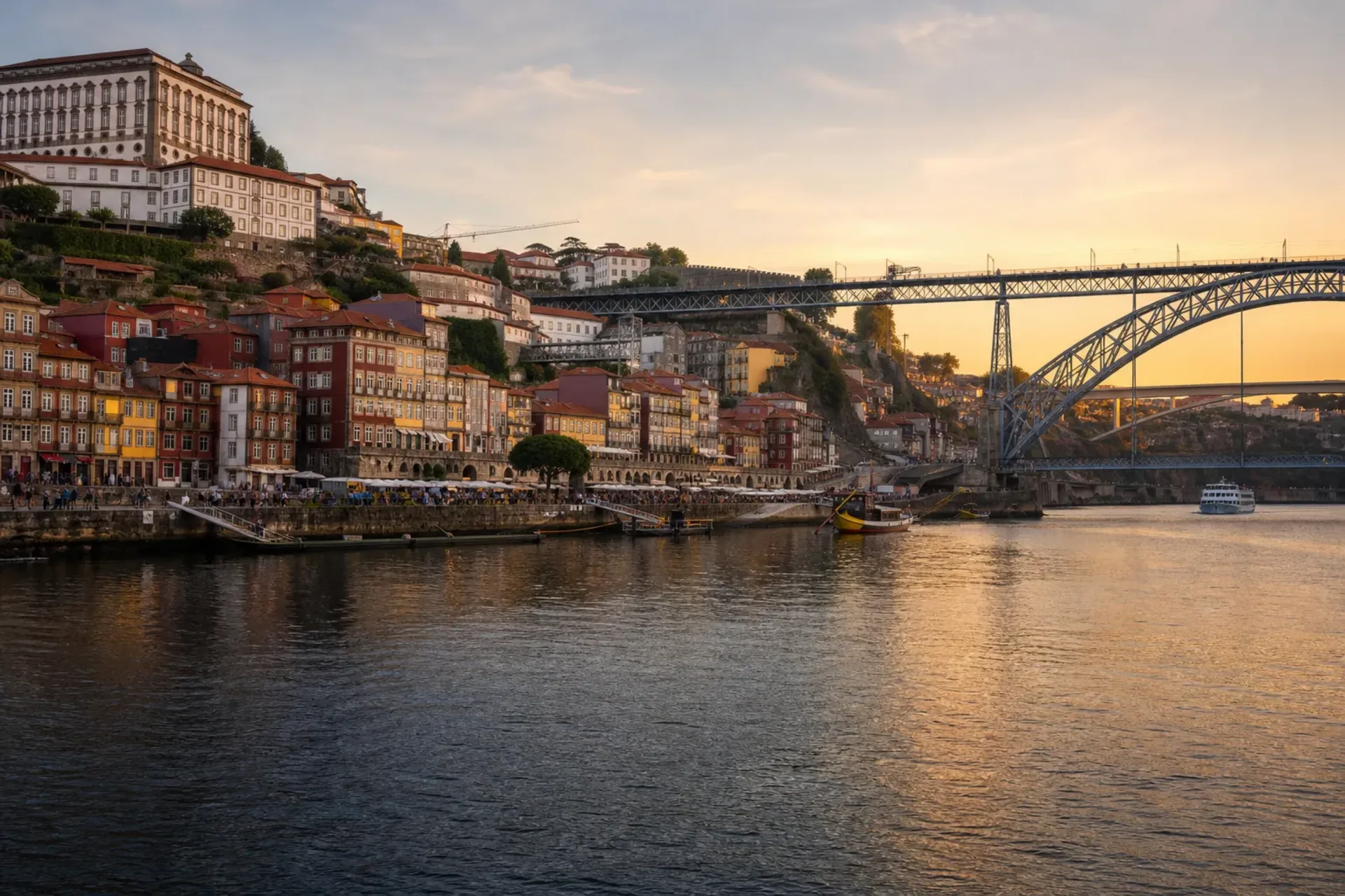 Portugal, Spain, France, Belgium-A beautiful sunset view of Porto's colourful Ribeira district along the river, a highlight of the Lisbon to Southampton cruise.