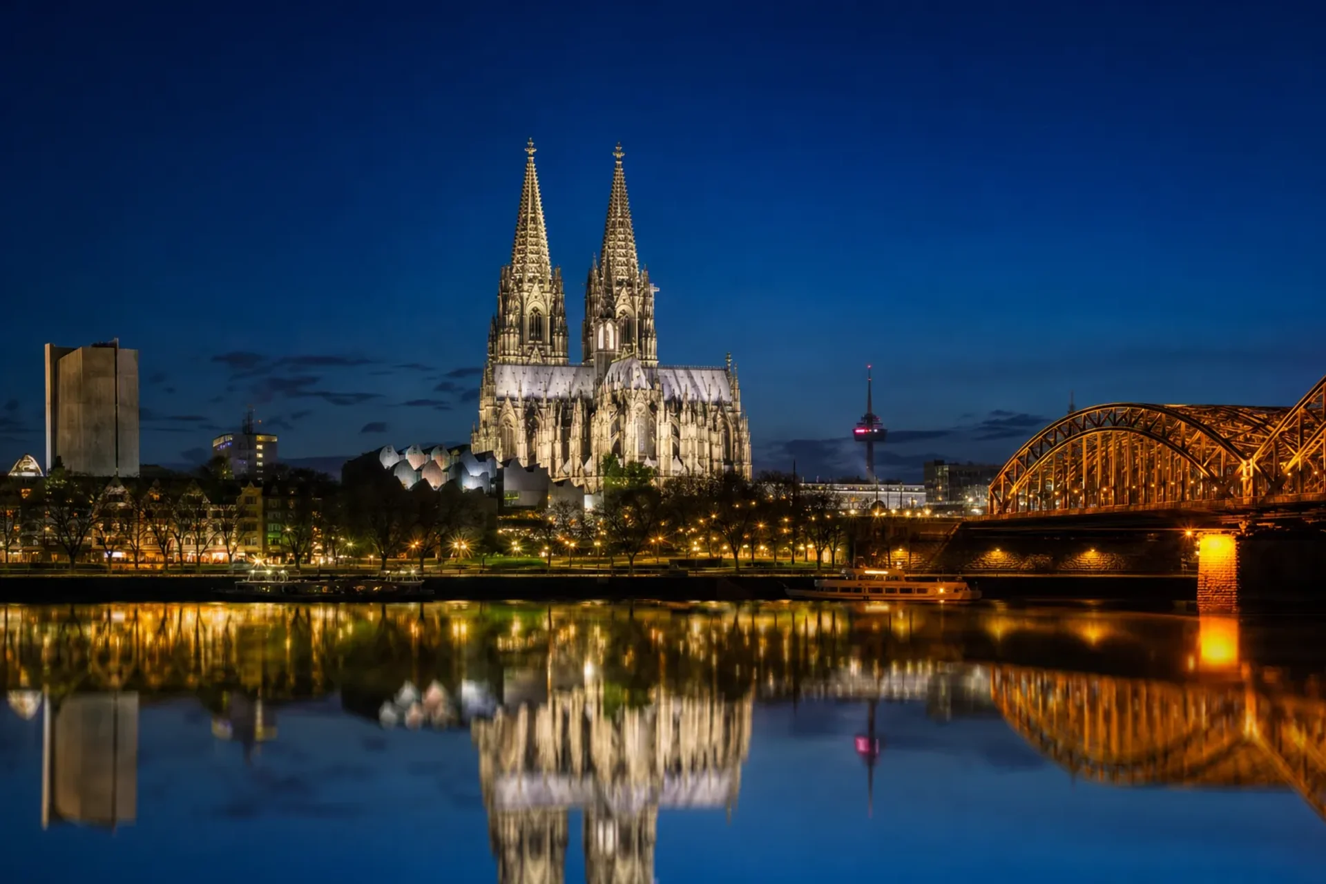 Germany & Netherlands-Cologne Cathedral illuminated at night along the river during a Rhine and Main tour.
